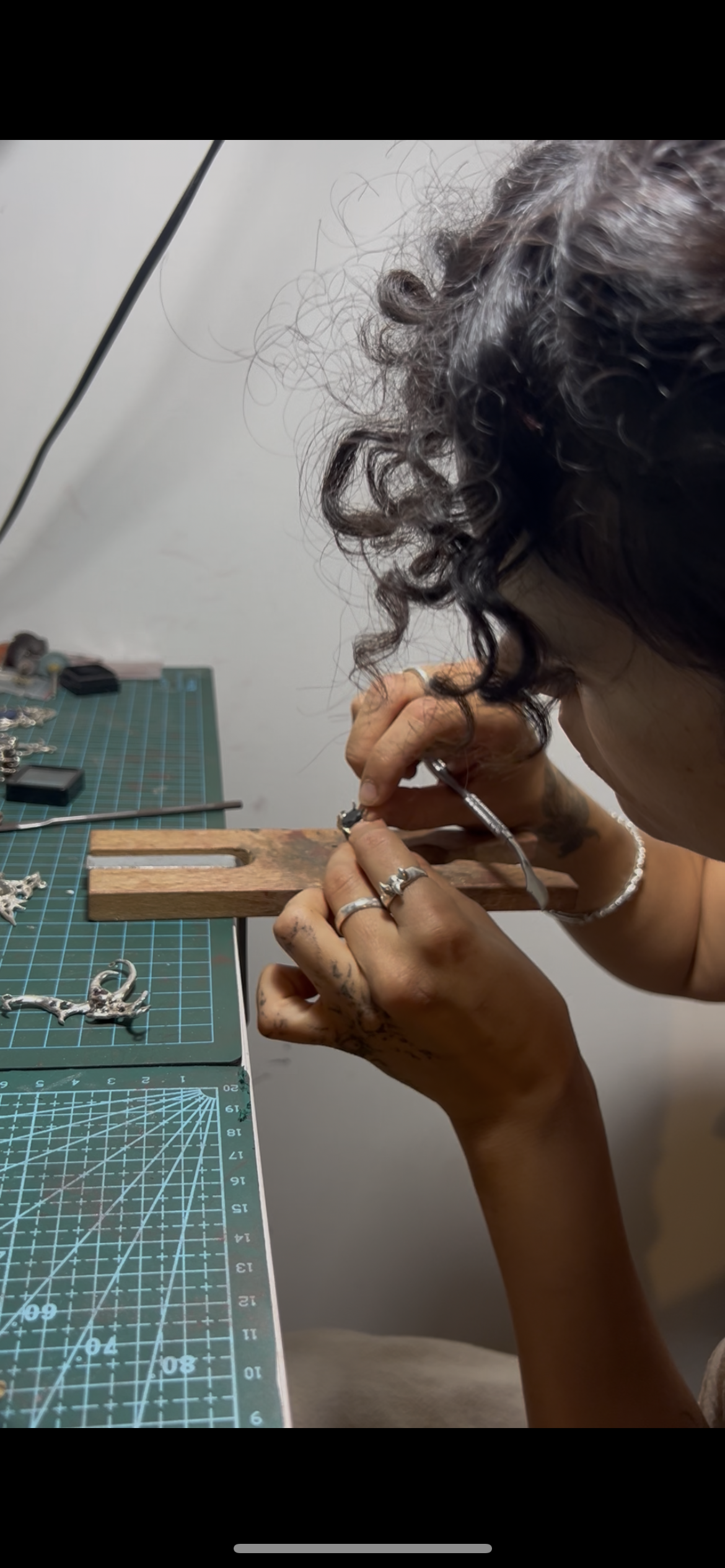 Sawing and piercing the cast silver at the bench